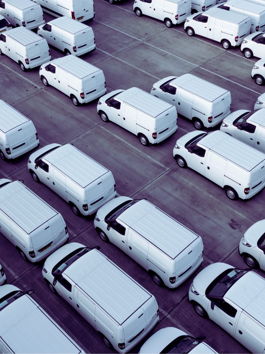 Aerial view of a large fleet of white vans