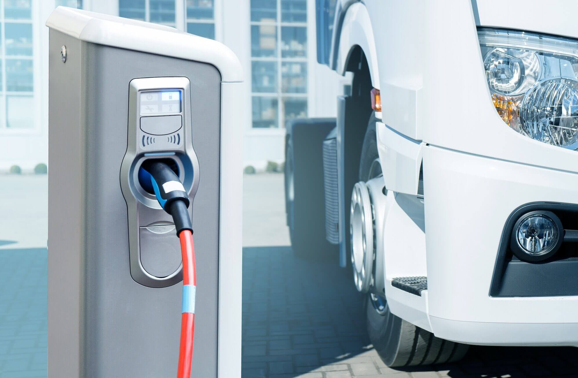 Electric Vehicles Charging Station On A Background Of A Truck